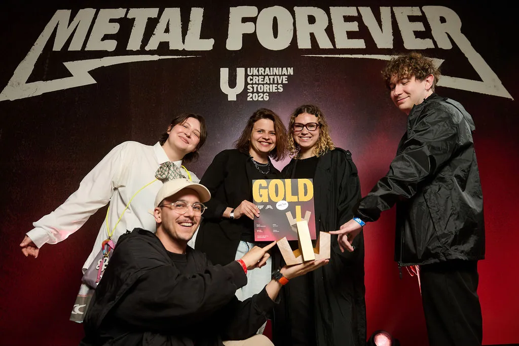 The team on stage holding a gold trophy at the Ukrainian Creative Stories awards